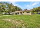 Traditional single-story home featuring a well-manicured lawn and shuttered windows at 1478 Harmony Dr, Port Charlotte, FL 33952