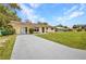 Charming single-story home with a well-maintained lawn and long driveway at 1478 Harmony Dr, Port Charlotte, FL 33952