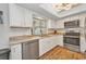 Well-lit kitchen features white cabinets, stainless steel appliances, and lovely granite countertops at 1478 Harmony Dr, Port Charlotte, FL 33952