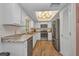 Bright kitchen featuring white cabinets, stainless steel appliances, and modern lighting fixtures at 1478 Harmony Dr, Port Charlotte, FL 33952