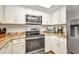 Modern kitchen featuring stainless steel appliances, granite countertops, and bright white cabinetry at 1478 Harmony Dr, Port Charlotte, FL 33952