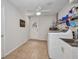 Well-lit laundry room with white appliances, storage shelves, and a utility sink at 1478 Harmony Dr, Port Charlotte, FL 33952