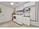 Well-lit laundry room featuring a modern washer, dryer, and sink with ample storage space at 1478 Harmony Dr, Port Charlotte, FL 33952