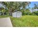 View of metal storage shed in green backyard at 1478 Harmony Dr, Port Charlotte, FL 33952