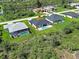 The backyard features a large heated pool, mature landscaping, and a lush green yard for entertaining at 15741 Autry Cir, Port Charlotte, FL 33981