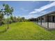 Backyard featuring a well-maintained lawn and a black metal fence, providing privacy at 15741 Autry Cir, Port Charlotte, FL 33981