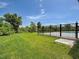 Spacious backyard featuring a green lawn and a black metal fence enclosing the area at 15741 Autry Cir, Port Charlotte, FL 33981
