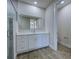 Modern bathroom featuring a glass shower enclosure, bright mirror, and white vanity at 15741 Autry Cir, Port Charlotte, FL 33981