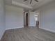 Bright bedroom showing open doorway, neutral color palette, and wood-look tile flooring at 15741 Autry Cir, Port Charlotte, FL 33981