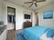 Stylishly decorated bedroom with a blue bedspread, TV, and closet, creating a cozy atmosphere at 15741 Autry Cir, Port Charlotte, FL 33981