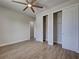 Bright bedroom showcasing modern sliding closet doors and an open doorway, enhanced by wood-look flooring at 15741 Autry Cir, Port Charlotte, FL 33981