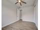 Bright bedroom with wood-look flooring, closet, doorway, and ceiling fan for comfort at 15741 Autry Cir, Port Charlotte, FL 33981