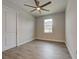 Cozy bedroom featuring wood-look flooring, neutral walls, and a window offering natural light at 15741 Autry Cir, Port Charlotte, FL 33981