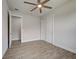 Bedroom showcasing wood-look flooring, closet, and ceiling fan for a comfortable living space at 15741 Autry Cir, Port Charlotte, FL 33981