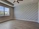 Inviting bedroom with wood look tile flooring and decorative wall adding style and texture at 15741 Autry Cir, Port Charlotte, FL 33981