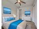 Beautiful bedroom setup with decor, ceiling fan, and blue accents against neutral walls at 15741 Autry Cir, Port Charlotte, FL 33981