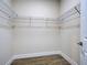 Walk-in closet with wire shelving and wood-look tile flooring provides ample and organized storage space at 15741 Autry Cir, Port Charlotte, FL 33981
