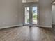 Bright foyer showcasing stylish wood-look tile and a welcoming entry at 15741 Autry Cir, Port Charlotte, FL 33981