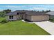 This beautiful single-Gathering home features an attached three-car garage, and a well-manicured lawn at 15741 Autry Cir, Port Charlotte, FL 33981