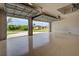 Open garage with epoxy floors offering outdoor views and a glimpse of the neighborhood at 15741 Autry Cir, Port Charlotte, FL 33981