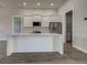 Bright kitchen featuring white cabinets, stainless steel appliances, and a center island at 15741 Autry Cir, Port Charlotte, FL 33981