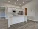 Modern kitchen with white cabinets, stainless steel appliances, and a large center island at 15741 Autry Cir, Port Charlotte, FL 33981