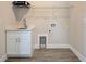Convenient laundry room with white cabinets, quartz counters and wire shelving for storage at 15741 Autry Cir, Port Charlotte, FL 33981