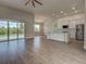 Open-concept floor plan with a view of the pool through sliding glass doors at 15741 Autry Cir, Port Charlotte, FL 33981