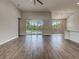 Expansive open-concept living area with wood-look tile floors at 15741 Autry Cir, Port Charlotte, FL 33981