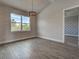 Comfortable living room with wood-look tile floors and a large window with a view at 15741 Autry Cir, Port Charlotte, FL 33981