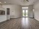 Open-concept floorplan with wood-look tile, seamlessly connecting the kitchen and living spaces at 15741 Autry Cir, Port Charlotte, FL 33981