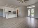A spacious living room integrates seamlessly with a kitchen, featuring modern wood-look tiling at 15741 Autry Cir, Port Charlotte, FL 33981