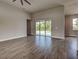 Bright living room featuring wood-look tile floors and sliding glass doors to the outdoor pool at 15741 Autry Cir, Port Charlotte, FL 33981
