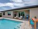 Inviting backyard pool area with outdoor seating and dining at 15741 Autry Cir, Port Charlotte, FL 33981