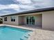 Backyard pool with brick patio and sliding glass doors at 15741 Autry Cir, Port Charlotte, FL 33981
