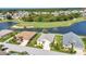 Aerial view of homes along a lake, featuring a golf course and water fountain at 1617 Britannia Blvd, Punta Gorda, FL 33980