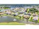Community aerial view overlooking single-Gathering homes along a large lake with a fountain at 1617 Britannia Blvd, Punta Gorda, FL 33980