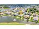 Beautiful waterfront home featuring lush landscaping and a serene pond view with a relaxing fountain at 1617 Britannia Blvd, Punta Gorda, FL 33980