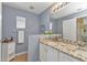 Bathroom featuring double sinks, granite countertops, and a light grey wall color at 1617 Britannia Blvd, Punta Gorda, FL 33980