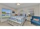 Bright bedroom with nautical decor, large windows, and a view of the lake at 1617 Britannia Blvd, Punta Gorda, FL 33980