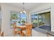 Cozy breakfast nook with a round table, natural light, and sliding door access to the lanai at 1617 Britannia Blvd, Punta Gorda, FL 33980