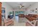 Cozy living room with leather sofas, ceiling fan, and view of the lake at 1617 Britannia Blvd, Punta Gorda, FL 33980