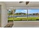 Enclosed patio featuring large windows overlooking a picturesque lake with fountain at 1617 Britannia Blvd, Punta Gorda, FL 33980