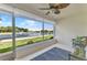 Enclosed patio featuring large windows overlooking a picturesque lake and fountain at 1617 Britannia Blvd, Punta Gorda, FL 33980