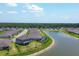 This aerial shot captures the home's location with a beautiful pond view and a community pool nearby at 16833 Terrapin Key Dr, Port Charlotte, FL 33953