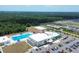 This aerial shot showcases the community center with its pool, playground, and ample parking at 16833 Terrapin Key Dr, Port Charlotte, FL 33953