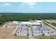 An aerial shot shows the community center with its large parking lot, pool, and recreational facilities at 16833 Terrapin Key Dr, Port Charlotte, FL 33953