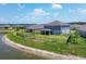 This home features a well-maintained lawn, secure black fencing, and a scenic pond view for outdoor enjoyment at 16833 Terrapin Key Dr, Port Charlotte, FL 33953