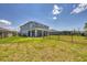 Spacious backyard features a covered patio, well-maintained lawn, and black iron fence, offering privacy at 16833 Terrapin Key Dr, Port Charlotte, FL 33953