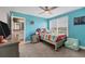 Bright bedroom featuring a colorful bed, a large window, and an en-suite bathroom at 16833 Terrapin Key Dr, Port Charlotte, FL 33953